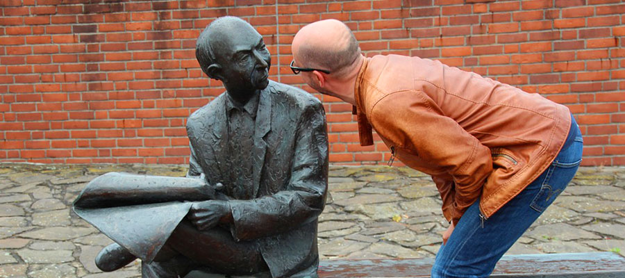 Man looks into the face of a statue